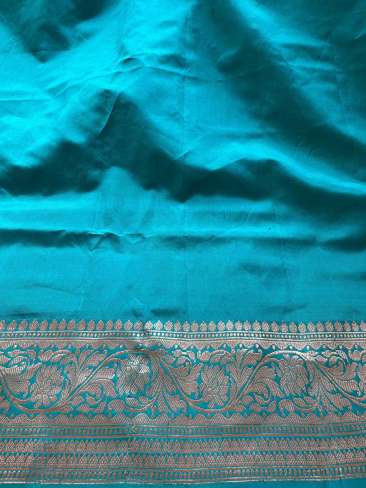 A soft light green Banarasi saree woven with delicate motifs and timeless artistry.