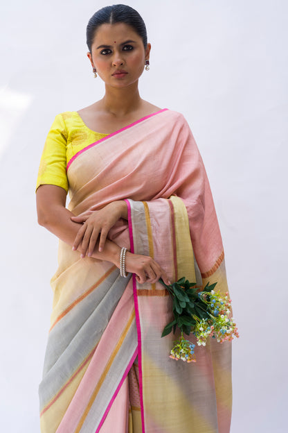 A woman modeling a multicolored Banarasi saree in soft tusser silk with golden zari stripes and pink palla