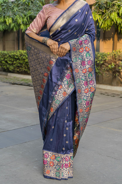 Timeless charm in a blue Banarasi saree with floral artistry and zari borders, matched with a pink blouse piece 