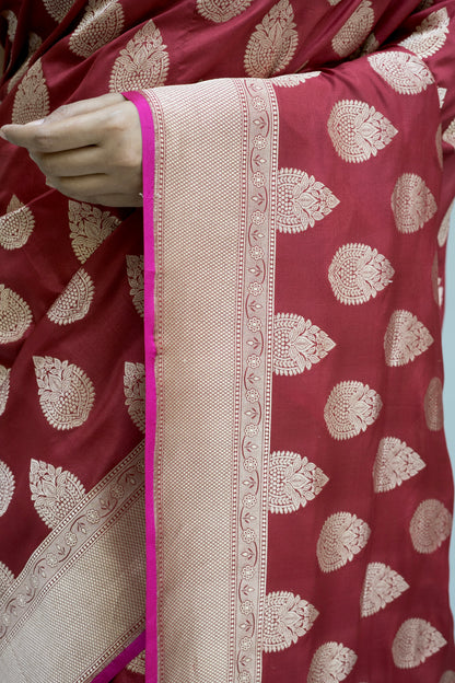 Maroon Banarasi richness with crisp white patterns, captured on a calm grey setting