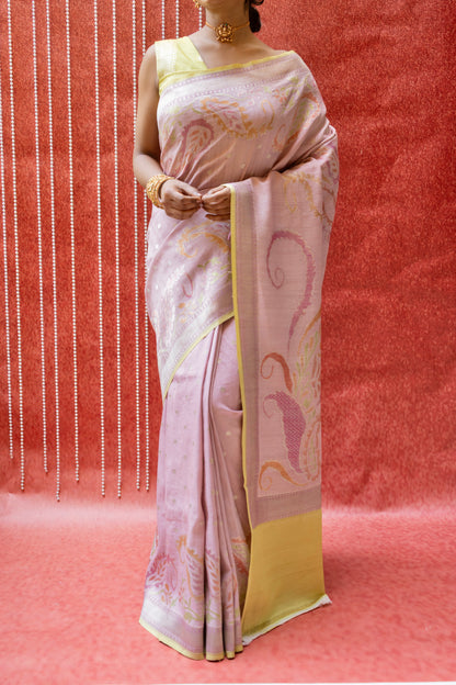 Close-up of a model wearing a luxury Banarasi saree with detailed floral motifs and gold jewelry