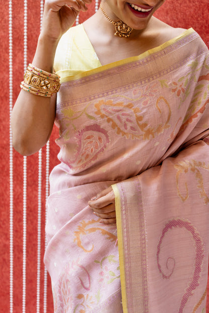 Person styled in a luxury Banarasi saree featuring rich floral designs and ornate gold jewelry