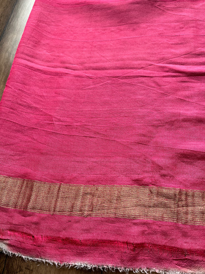 Traditional Indian Banarasi saree in tusser silk featuring intricate golden zari work and vibrant pink palla