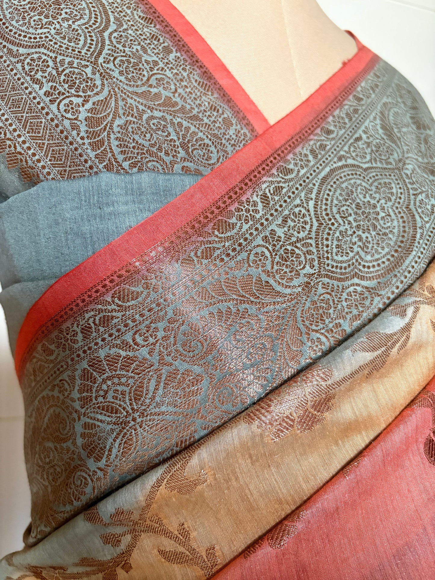 Elegant luxury Banarasi saree featuring floral patterns displayed on a mannequin