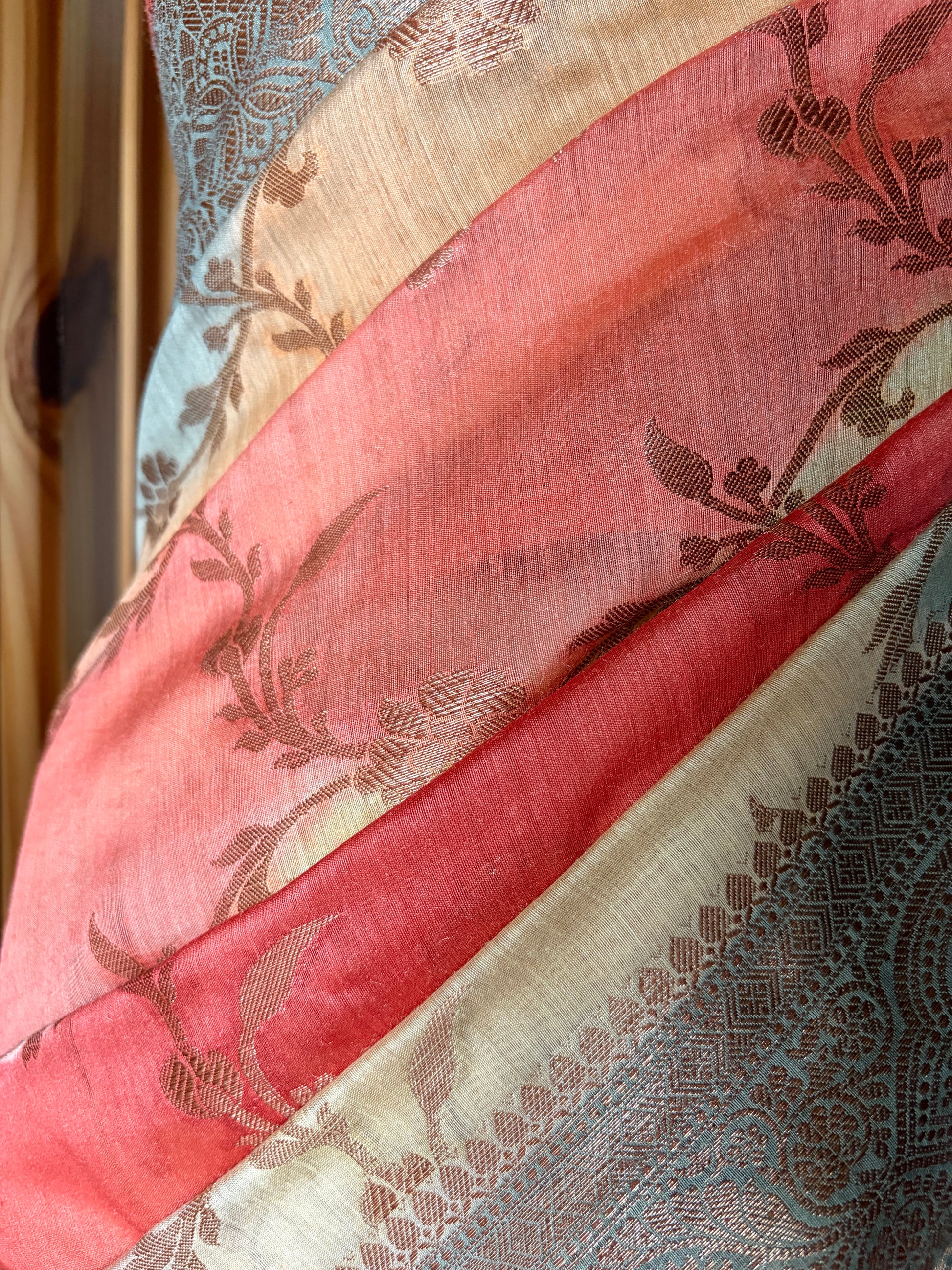 Floral design luxury Banarasi saree displayed on a mannequin against a white wall