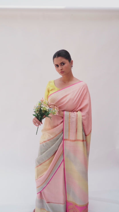 Luxury handloom Banarasi saree paired with a yellow blouse, golden zari stripes, and pink palla