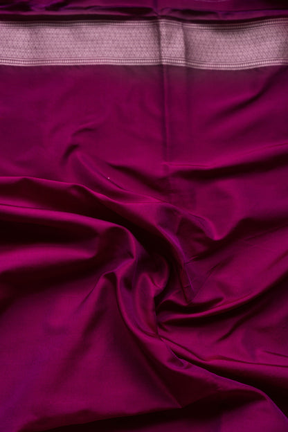 A vibrant pink Banarasi saree adorned with exquisite traditional motifs.
