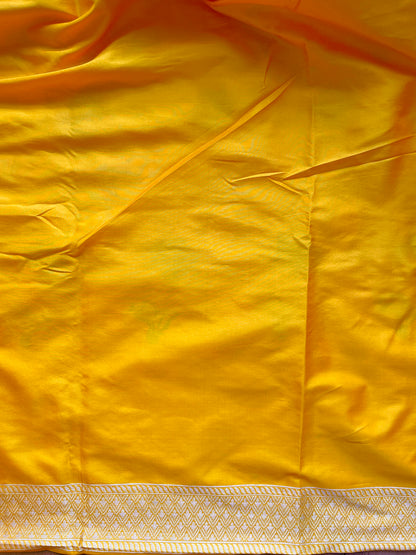 Yellow Katan Multi-Meena Banarasi elegance with floral artistry, shimmering zari work, and a matching solid blouse piece.