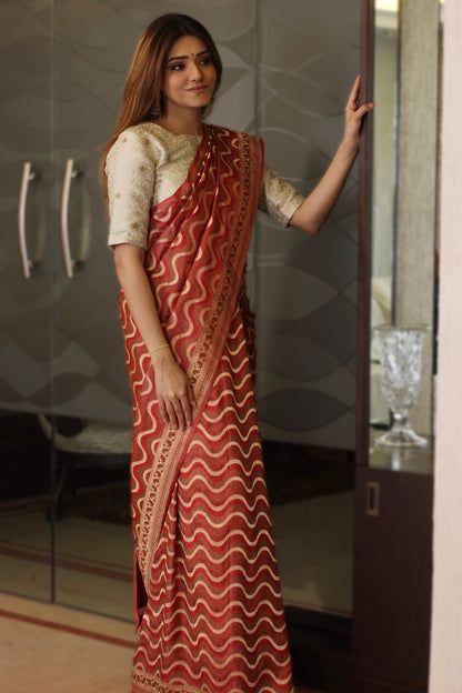 A classic red Banarasi saree adorned with heritage-inspired designs and luxurious detailing.