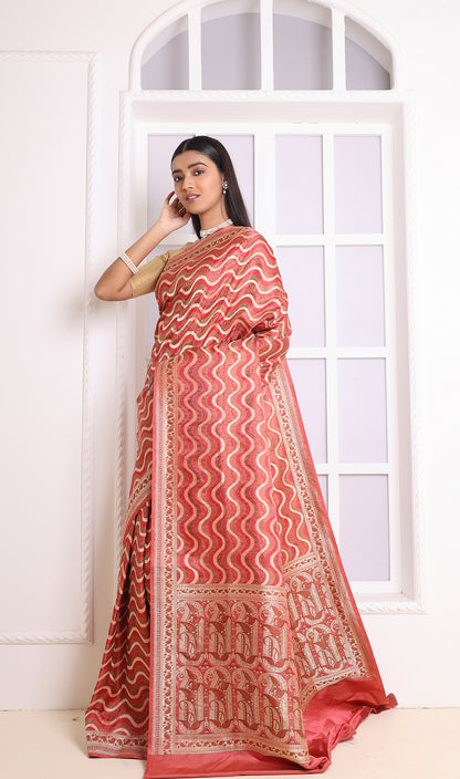 A regal red Banarasi saree featuring intricate patterns and luxurious weaving