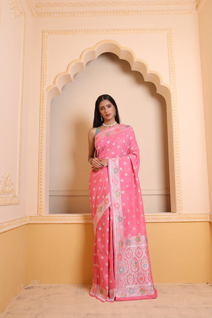 A light pink Banarasi saree woven with artisanal zari work, blending sophistication with classic Banarasi beauty.