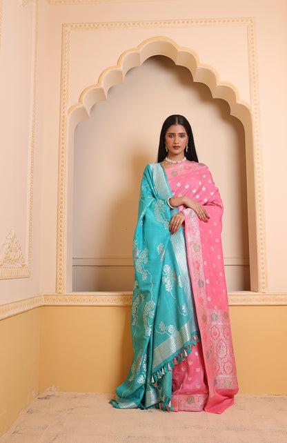 A light pink Banarasi saree featuring intricate zari motifs, radiating soft grace and traditional charm.
