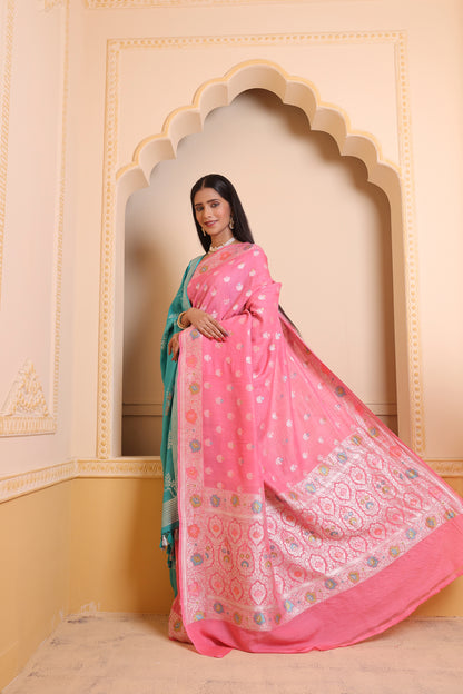 A woman wearing a light pink Banarasi saree with rich zari detailing, perfect for subtle festive elegance.