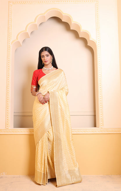 A light cream Banarasi saree highlighted with artisanal zari patterns, perfect for graceful festive styling.