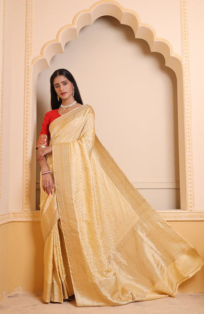 A light cream Banarasi saree with delicate zari motifs, blending subtle elegance with traditional charm.